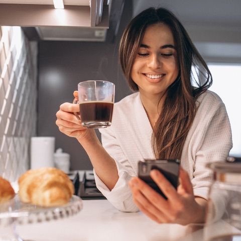 Girl having a coffee in the kitchen